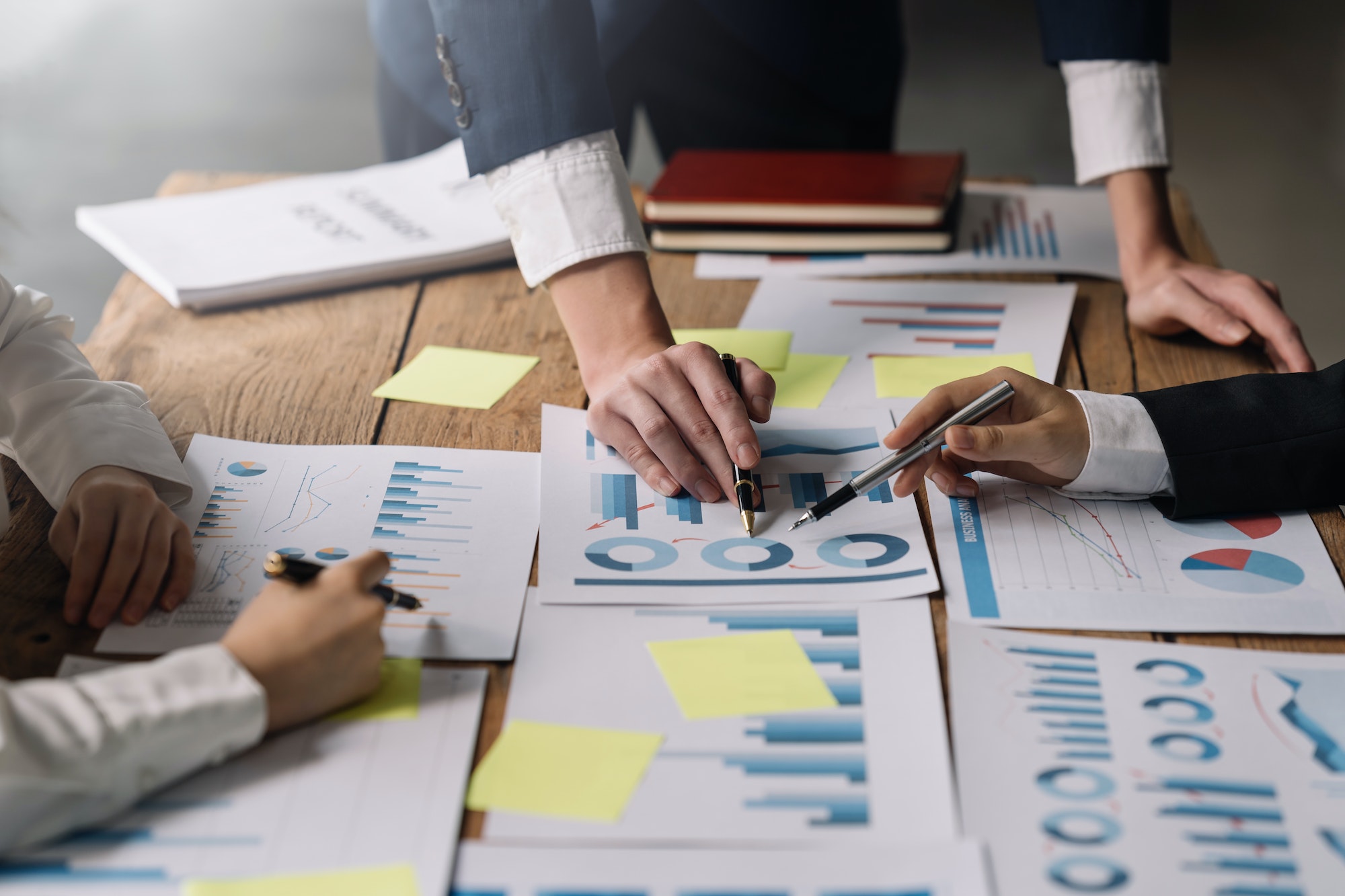 Group of businessmen explaining the concept marketing strategy analyze graphs and charts on corporat