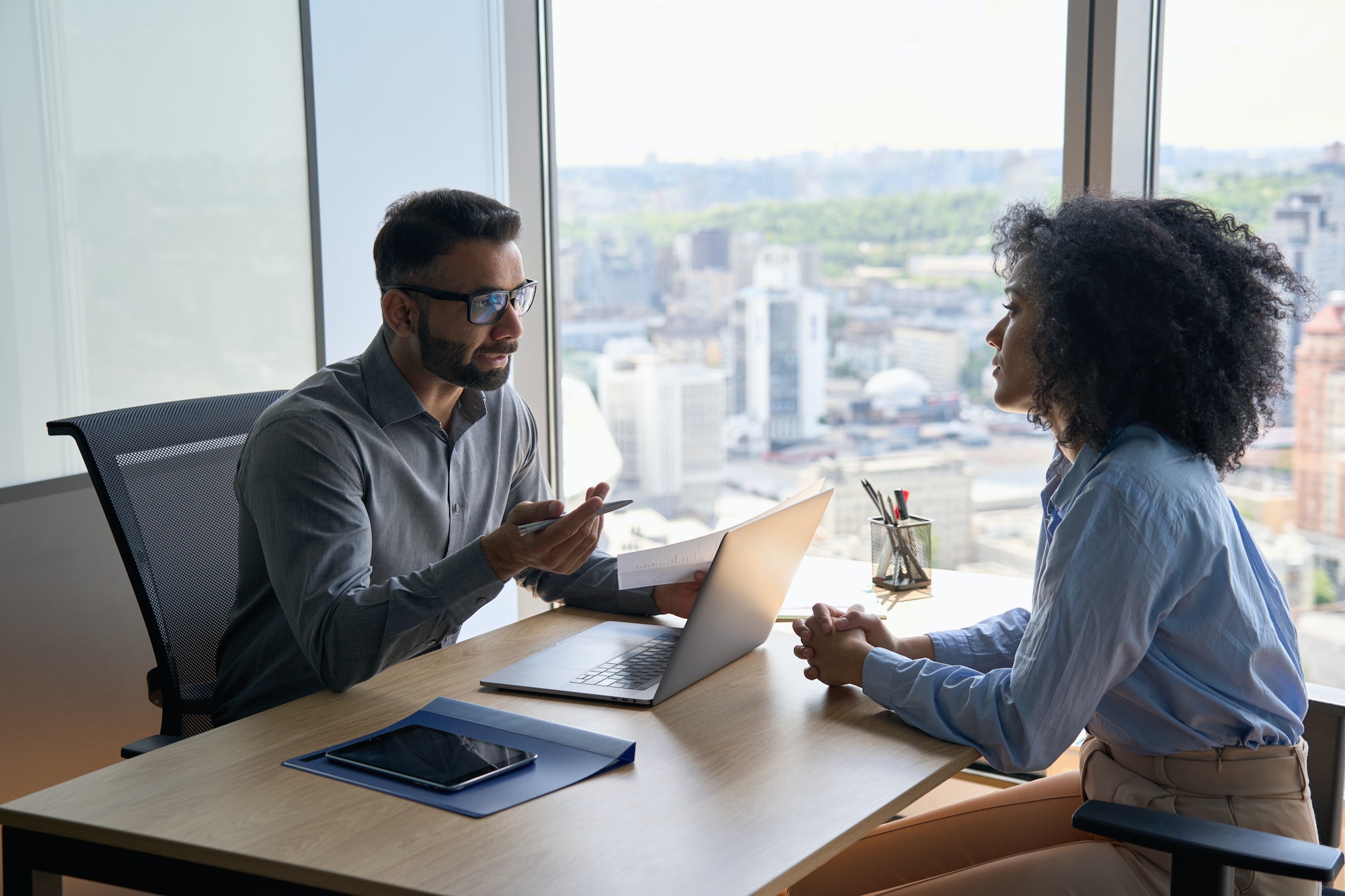 Indian latin hr manager on interview with African American applicant in office.